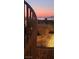Beautiful Las Vegas city view at dusk from an elevated deck with spiral staircase and stonework at 16 Mallard Creek Trl, Henderson, NV 89052