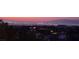 Spectacular twilight view of the Las Vegas skyline and surrounding mountains from a beautiful home at 16 Mallard Creek Trl, Henderson, NV 89052