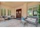 Inviting courtyard area with elegant double doors, seating, and stylish decor at 16 Mallard Creek Trl, Henderson, NV 89052