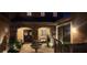 Cozy courtyard at night featuring a fountain, seating area, and beautiful stone archway at 16 Mallard Creek Trl, Henderson, NV 89052