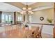 Open-concept dining area with wood table and chairs flows into the living room at 16 Mallard Creek Trl, Henderson, NV 89052
