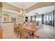 Open-concept dining area with wood table and chairs flows into the living room at 16 Mallard Creek Trl, Henderson, NV 89052