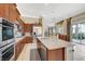 A full kitchen boasts stainless steel appliances, granite countertops and an island with a stainless steel sink at 16 Mallard Creek Trl, Henderson, NV 89052