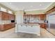 A spacious kitchen featuring custom wood cabinets, stainless steel appliances, and granite countertops on a central island at 16 Mallard Creek Trl, Henderson, NV 89052