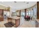 Spacious kitchen with granite countertops and stainless steel appliances, open to breakfast nook and patio at 16 Mallard Creek Trl, Henderson, NV 89052