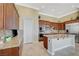 A gourmet kitchen boasting custom cabinets, granite countertops, and stainless steel appliances at 16 Mallard Creek Trl, Henderson, NV 89052