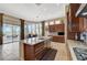 Gourmet kitchen featuring granite countertops, custom cabinets, and access to the outdoor living area at 16 Mallard Creek Trl, Henderson, NV 89052