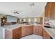 Kitchenette has granite countertops, and wood cabinets, connecting to living area at 16 Mallard Creek Trl, Henderson, NV 89052