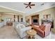 Spacious living room features a ceiling fan, fireplace, and seamless flow to the dining area at 16 Mallard Creek Trl, Henderson, NV 89052