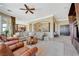 Expansive living room with tile floors, open archways, and comfortable leather seating at 16 Mallard Creek Trl, Henderson, NV 89052