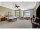 Spacious main bedroom features a four-poster bed, sitting area, and scenic views at 16 Mallard Creek Trl, Henderson, NV 89052