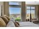 Relaxing main bedroom showcasing a luxurious bed, sitting area, and scenic backyard views at 16 Mallard Creek Trl, Henderson, NV 89052