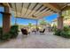 Spacious outdoor patio with a fire pit, comfortable seating, and a built-in bar area at 16 Mallard Creek Trl, Henderson, NV 89052