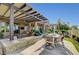 Gorgeous outdoor patio with fire pit, comfortable seating, and lush landscaping at 16 Mallard Creek Trl, Henderson, NV 89052