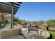 Beautiful covered patio seating area offers a tranquil outdoor dining experience with city views at 16 Mallard Creek Trl, Henderson, NV 89052