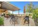 Enjoy the open air with seating at the stone-clad kitchen bar on the covered patio at 16 Mallard Creek Trl, Henderson, NV 89052