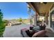 Spacious patio with a water feature, spiral staircase, comfortable seating area, and well-manicured greenery at 16 Mallard Creek Trl, Henderson, NV 89052