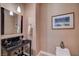 Chic powder room featuring a modern sink, stylish mirror, and elegant decor at 16 Mallard Creek Trl, Henderson, NV 89052