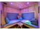 Inviting home sauna with wooden benches, soft cushions, stacked towels, and color changing lights for relaxation at 16 Mallard Creek Trl, Henderson, NV 89052