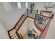 Open staircase with wrought iron railing, and a cozy seating area, bathed in natural light from multiple windows at 16 Mallard Creek Trl, Henderson, NV 89052