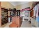Walk-in closet featuring built-in shelves and drawers for ample storage of clothes and luggage at 16 Mallard Creek Trl, Henderson, NV 89052