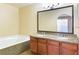 Elegant bathroom featuring a double vanity, soaking tub, and modern fixtures at 1836 N Decatur Blvd # 203, Las Vegas, NV 89108