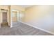 Bedroom features neutral carpet and mirrored closet with bright lighting and natural light from the window at 1836 N Decatur Blvd # 203, Las Vegas, NV 89108
