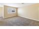 Large bedroom featuring plush carpet, neutral walls, and a bright, sunny window at 1836 N Decatur Blvd # 203, Las Vegas, NV 89108