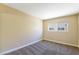 Cozy bedroom with neutral carpet and walls, bright window providing natural light into the space at 1836 N Decatur Blvd # 203, Las Vegas, NV 89108