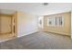 Spacious living room with new carpet, neutral walls, and natural light at 1836 N Decatur Blvd # 203, Las Vegas, NV 89108