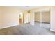 Carpeted main bedroom with a bathroom and mirrored closet for plenty of storage at 1836 N Decatur Blvd # 203, Las Vegas, NV 89108