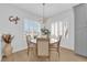 Cozy dining area with modern lighting fixture, plantation shutters, and a round wood table for four at 2279 Keego Harbor St, Henderson, NV 89052