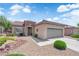 Charming single-story home with stone accents, desert landscaping, and a two-car garage in a sunny setting at 2279 Keego Harbor St, Henderson, NV 89052