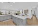 Modern kitchen with an island that opens to the living area and lots of natural light at 2279 Keego Harbor St, Henderson, NV 89052