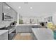 Beautiful kitchen with stainless steel appliances and an island with pendant lights that overlooks the living space at 2279 Keego Harbor St, Henderson, NV 89052