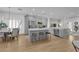 Bright, open kitchen features stainless steel appliances, a central island with seating, and light gray cabinetry at 2279 Keego Harbor St, Henderson, NV 89052