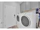 Convenient laundry room with washer, dryer, cabinets, and plenty of storage space at 2279 Keego Harbor St, Henderson, NV 89052