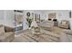 Bright living room with sliding glass door to the outdoor patio and neutral decor at 2279 Keego Harbor St, Henderson, NV 89052