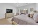 Light-filled main bedroom featuring a large bed, dresser and outdoor access at 2279 Keego Harbor St, Henderson, NV 89052