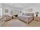 Spacious main bedroom with a sitting area, natural light and modern decor at 2279 Keego Harbor St, Henderson, NV 89052