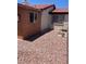 View of the backyard showcasing a low-maintenance landscape with gravel and the home's exterior at 2362 Sierra Sunrise St, Las Vegas, NV 89156
