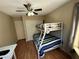 Bedroom featuring a bunk bed, ceiling fan, wood laminate flooring and a desk at 2362 Sierra Sunrise St, Las Vegas, NV 89156