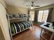 Bedroom featuring a bunk bed, ceiling fan, wood laminate flooring and a desk at 2362 Sierra Sunrise St, Las Vegas, NV 89156