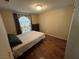 Bedroom with wood laminate flooring, single bed and a brown dresser at 2362 Sierra Sunrise St, Las Vegas, NV 89156