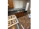 Well-lit kitchen featuring stainless steel appliances, wood cabinets, and tile backsplash at 2362 Sierra Sunrise St, Las Vegas, NV 89156
