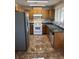 Traditional kitchen with wood cabinets, stainless steel appliances, tile backsplash and tile flooring at 2362 Sierra Sunrise St, Las Vegas, NV 89156