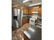 Charming kitchen featuring wood cabinets, stainless steel refrigerator, and modern appliances at 2362 Sierra Sunrise St, Las Vegas, NV 89156