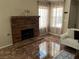 Cozy living room with a decorative fireplace and large windows offering plenty of natural light at 2362 Sierra Sunrise St, Las Vegas, NV 89156