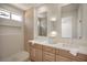 Bathroom featuring double sinks, quartz countertops, and a walk-in shower at 2561 Terrytown Ave, Henderson, NV 89052
