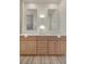 Bathroom vanity featuring double sinks, modern faucets, and light wood cabinets at 2561 Terrytown Ave, Henderson, NV 89052